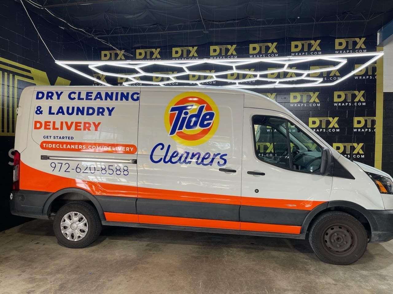 A white van with tide cleaners written on it