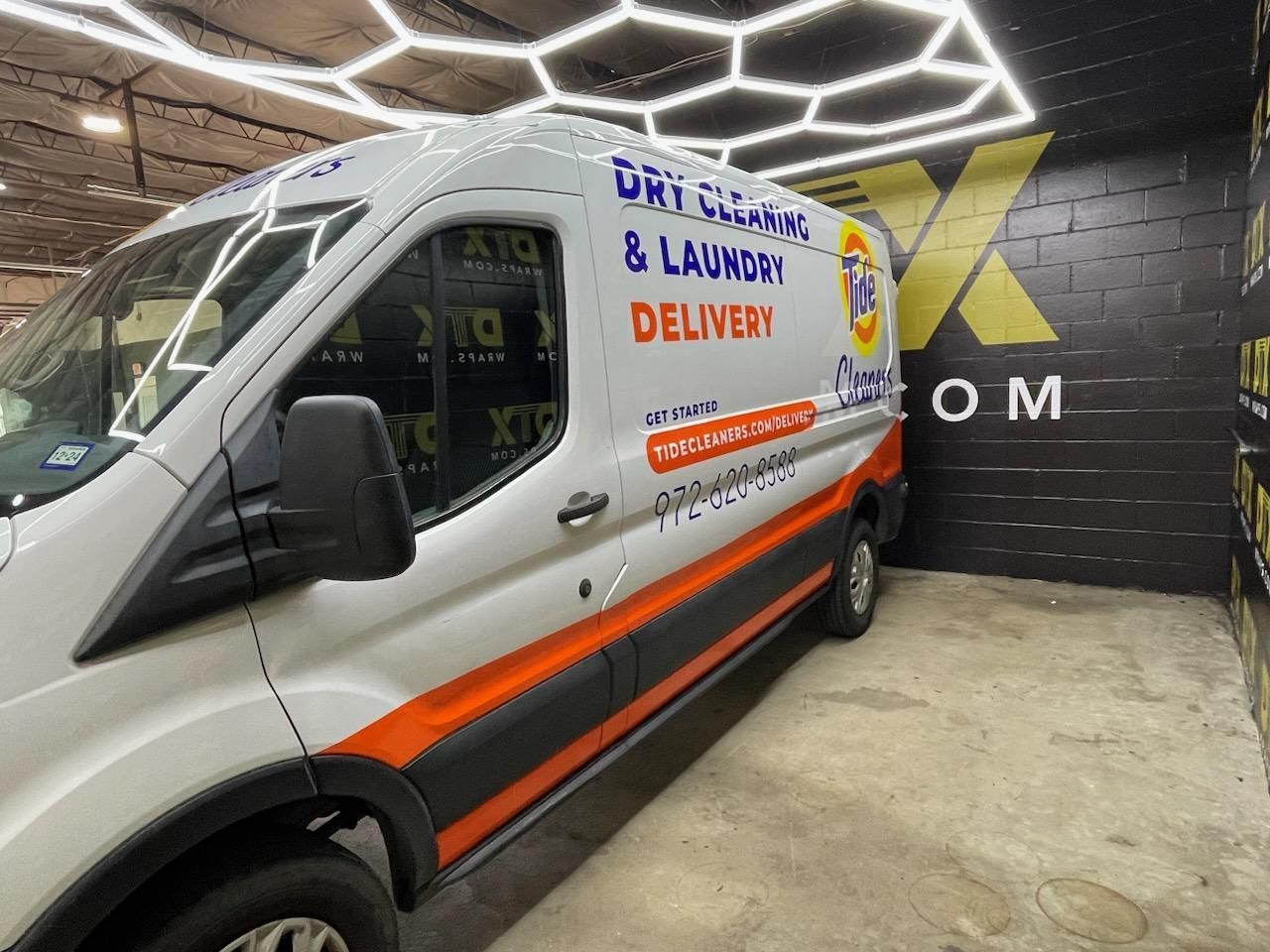 A white van that says dry cleaning and laundry delivery