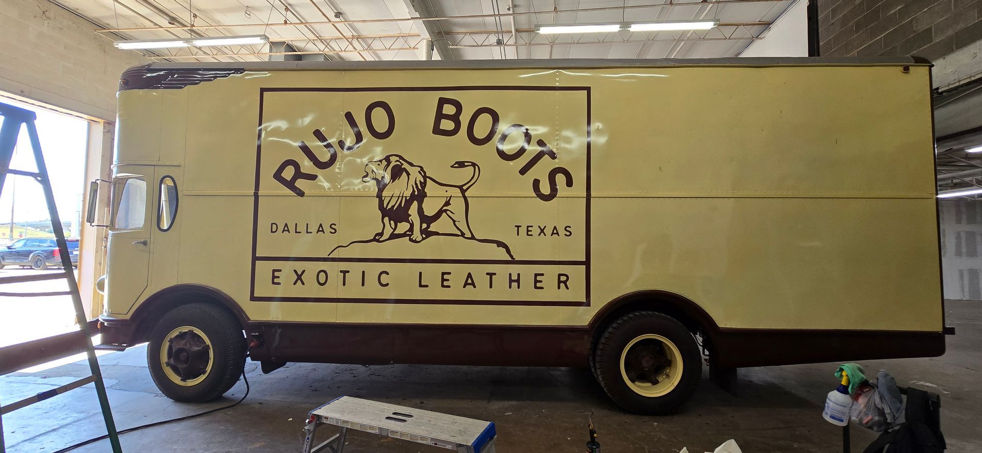 A yellow truck with the word exotic leather painted on it