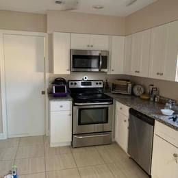 A kitchen with a stove , microwave , and dishwasher.