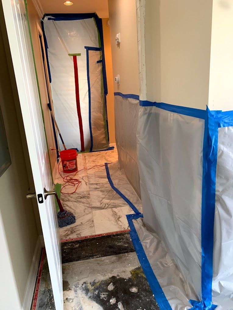 A hallway with a bucket and mop on the floor