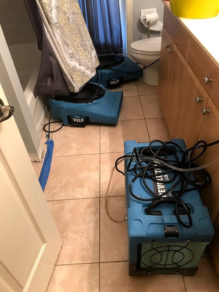 A bathroom with a toilet and a box that says utility on it
