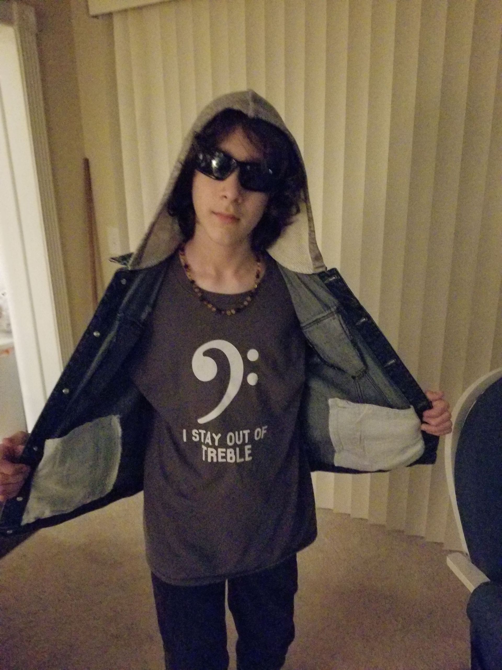 Young Milo with a bass clef shirt on and shades.