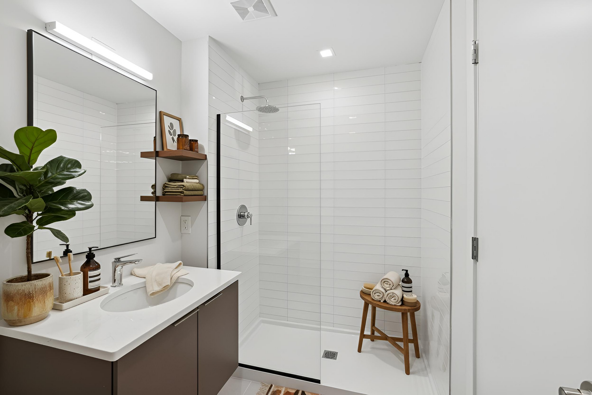 A bathroom with a toilet , sink and mirror.