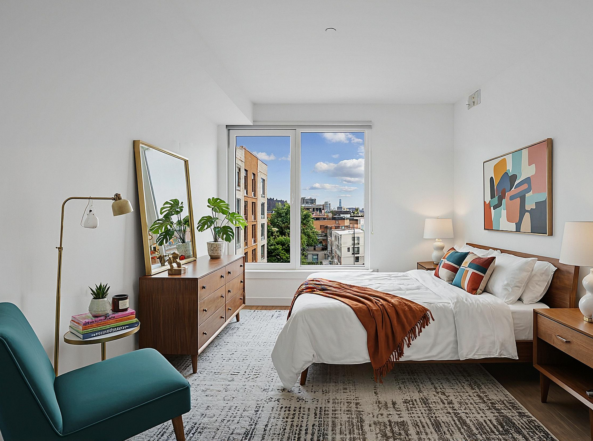 A bedroom with a bed and a window with a brick building in the background.