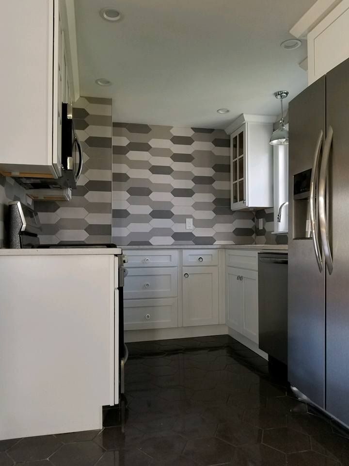 A kitchen with stainless steel appliances and white cabinets