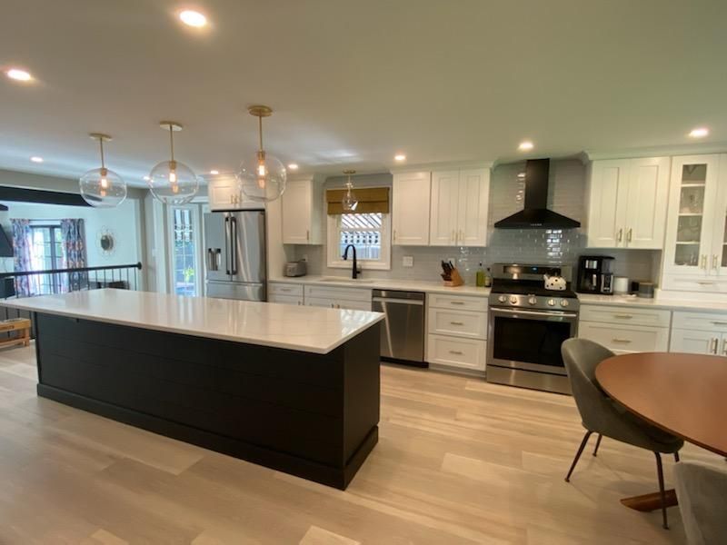 A kitchen with stainless steel appliances and a sign that says ea