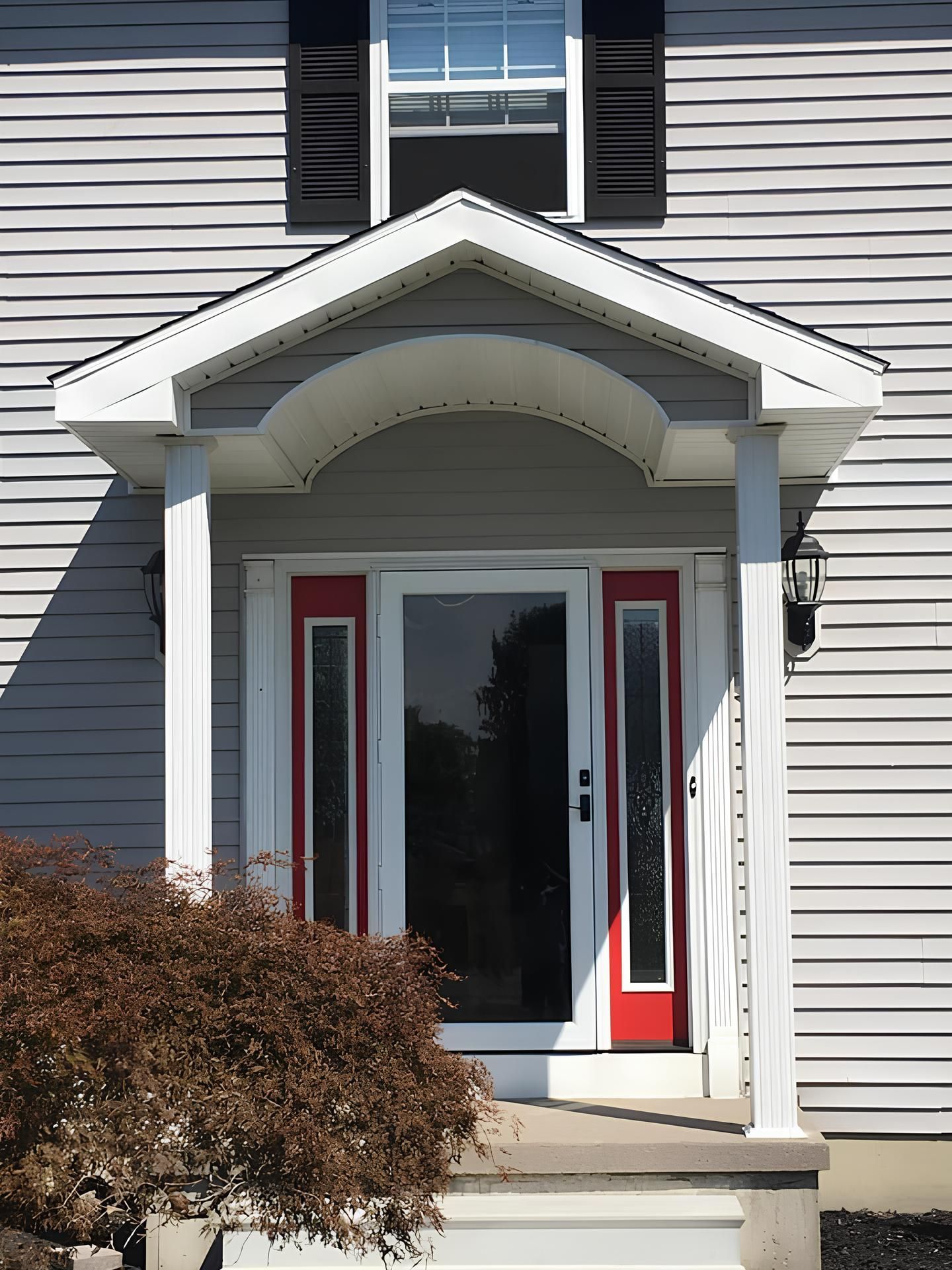 A house with a red door and a white porch