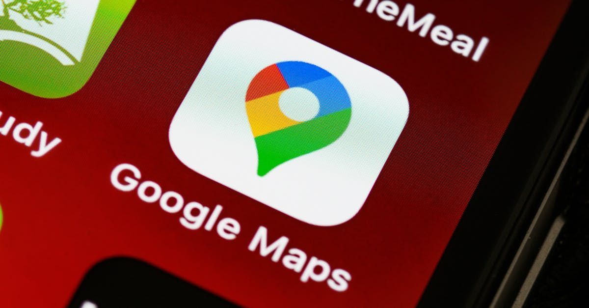 Google Maps app icon on a red phone screen.