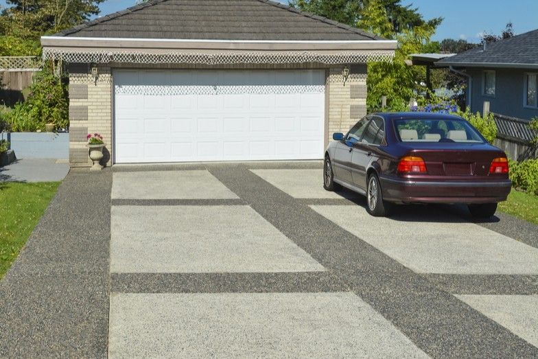 Concrete Driveway With Black Car