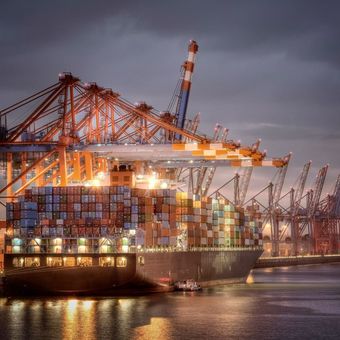 A Large Container Ship is Docked in a Harbor at Night — New Orleans, LA — Crescent Environmental Services