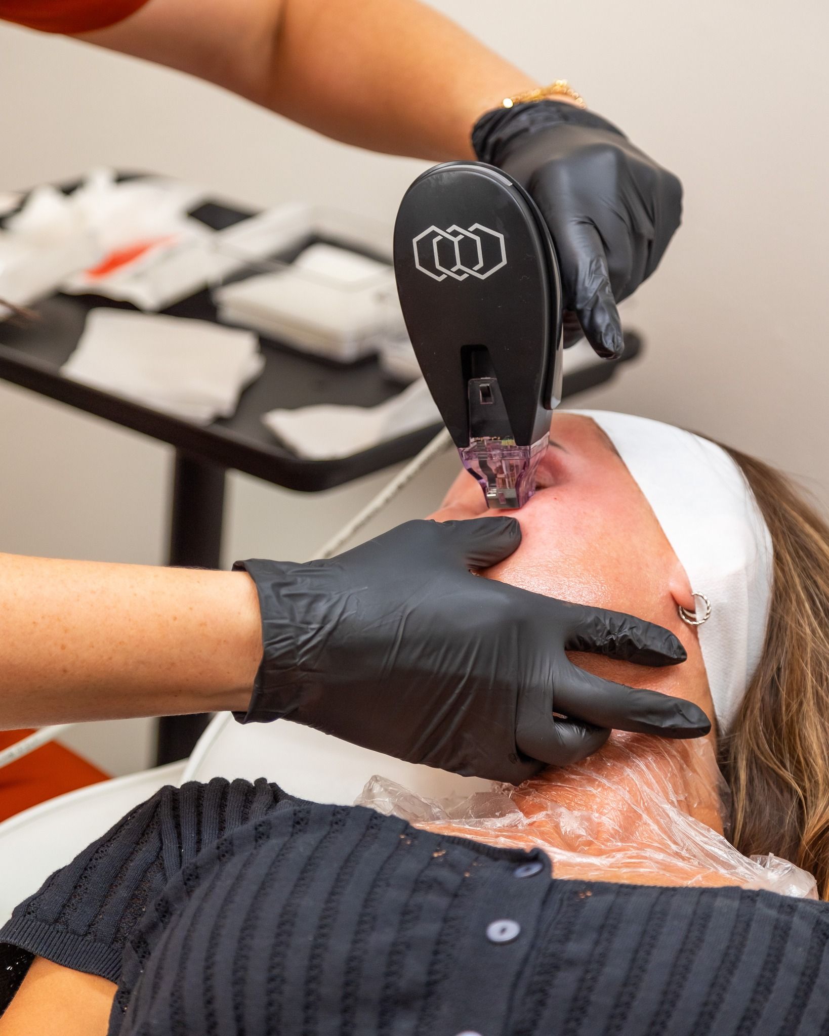 A woman is getting a facial treatment at a beauty salon.