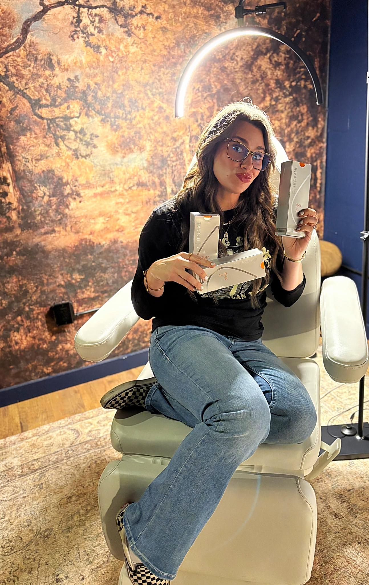 A woman is sitting in a chair holding a book.