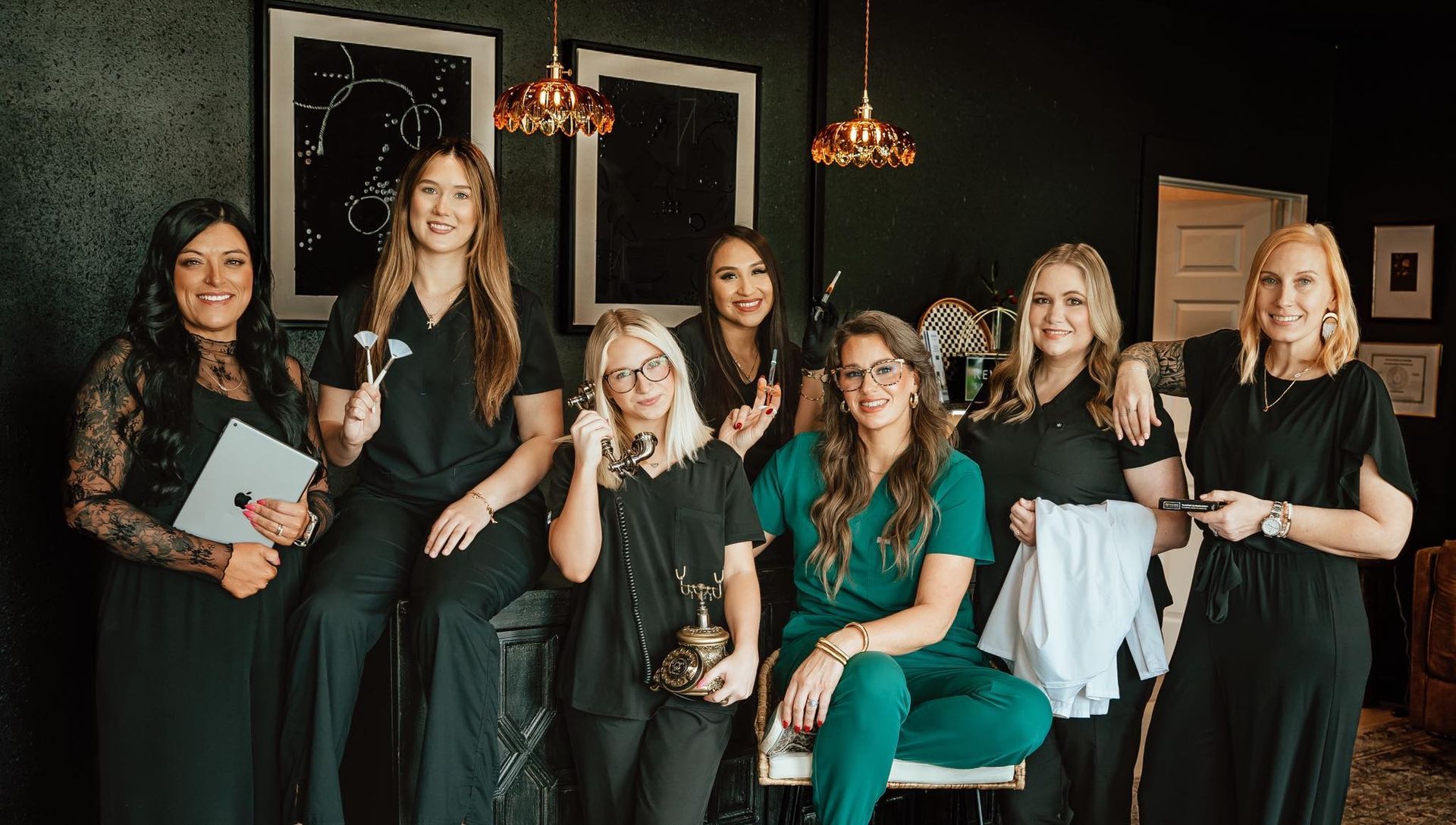 A group of women in scrubs are posing for a picture.