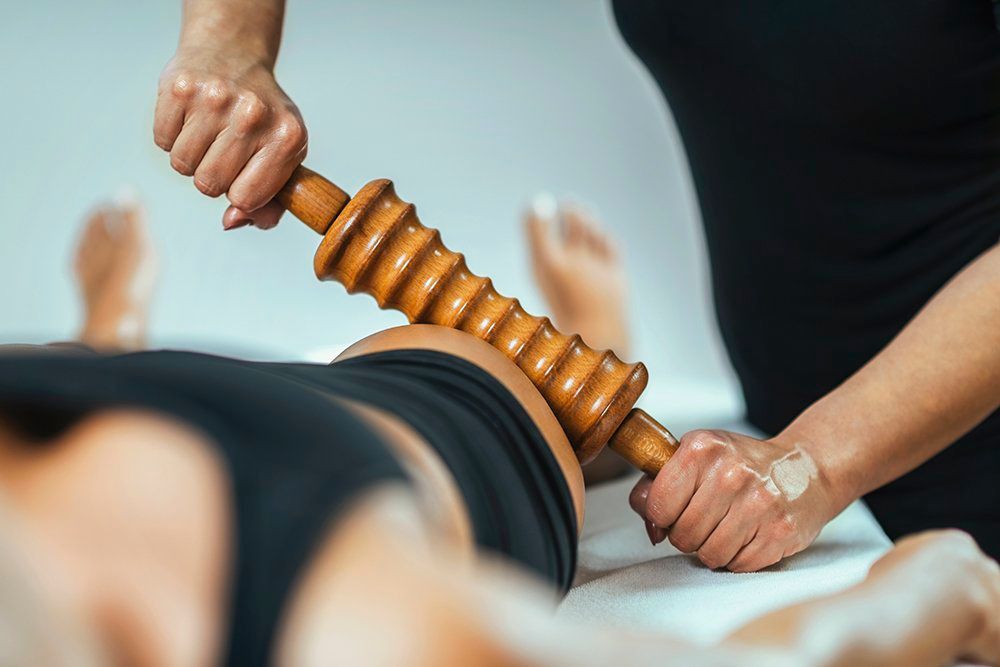 A woman is getting her legs waxed at a spa.