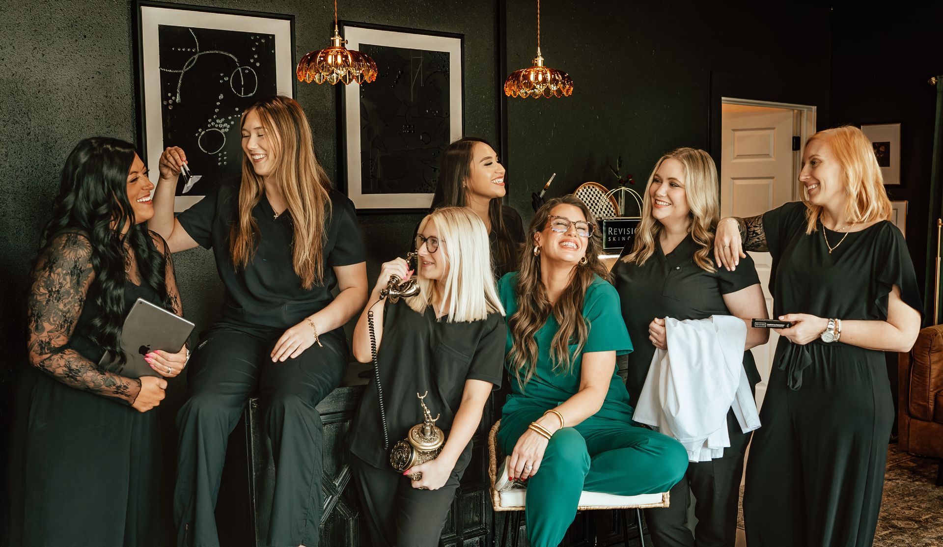 Group of women smiling and laughing together indoors.