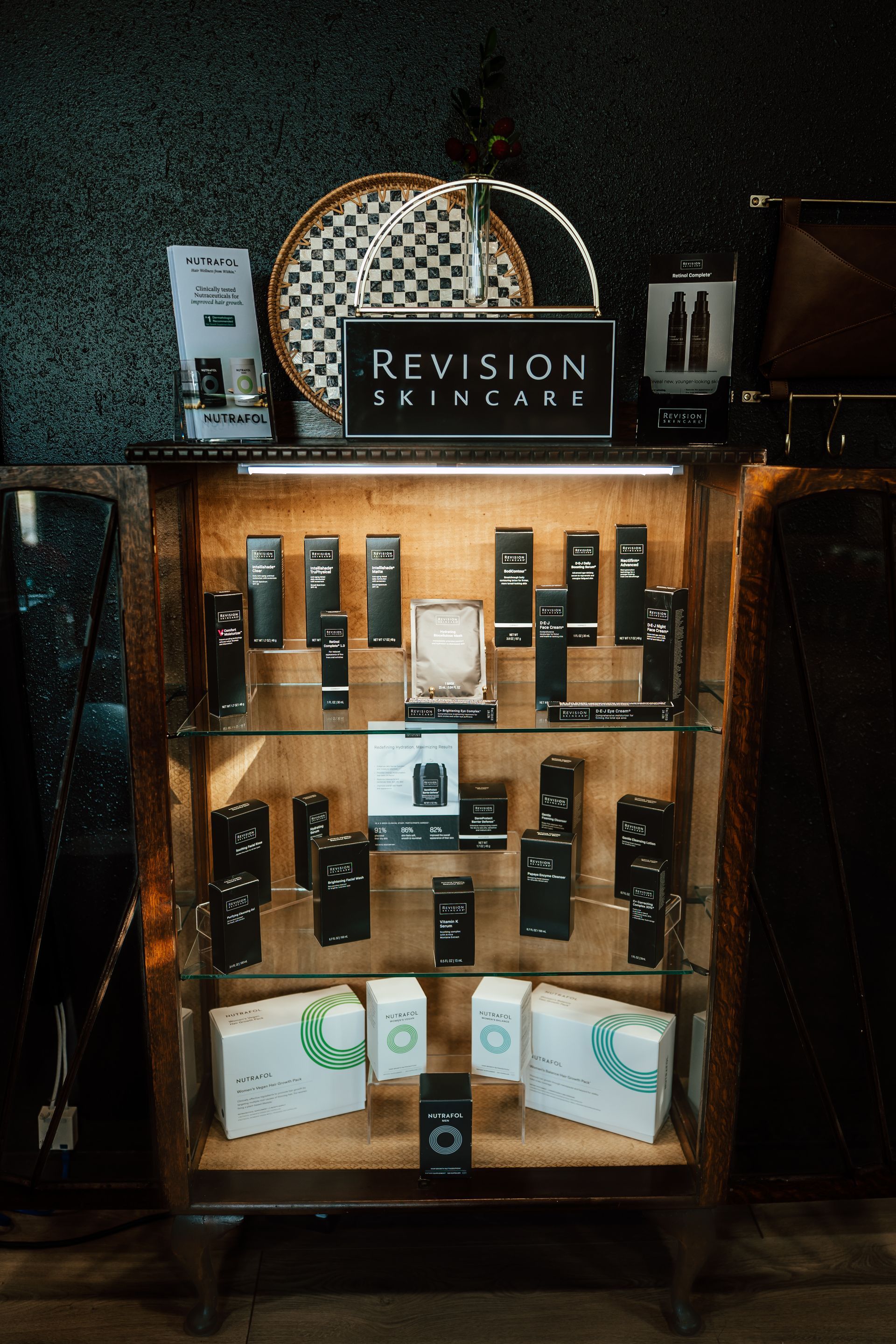 Display case filled with black and white Revision products, a sign, and other decorative items.