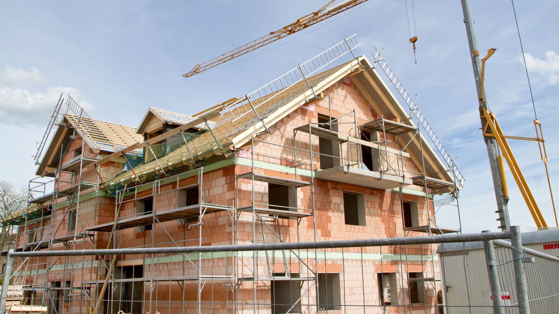 A house is being built with scaffolding and a crane — Gardena, CA — South Bay Scaffold & Ladder, Company Inc.