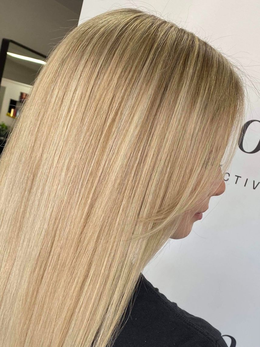 A close up of a woman 's blonde hair in a salon - Hairdresser in Mackay, QLD