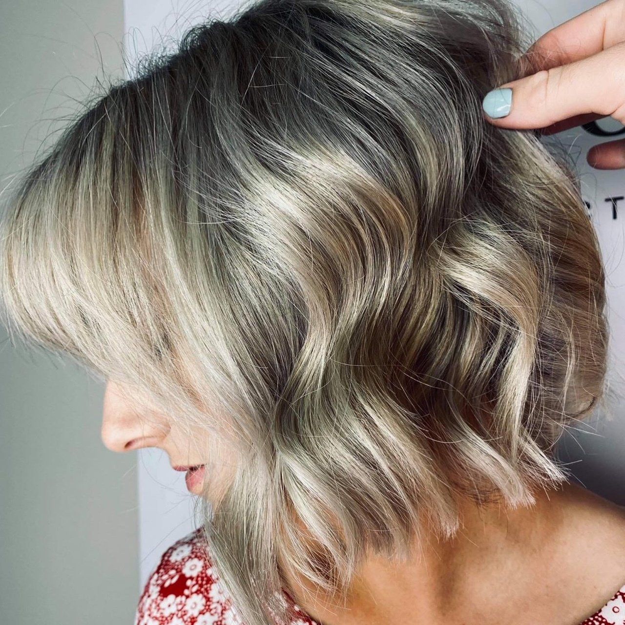 A woman with short blonde hair is getting her hair cut - Hairdresser in Mackay, QLD