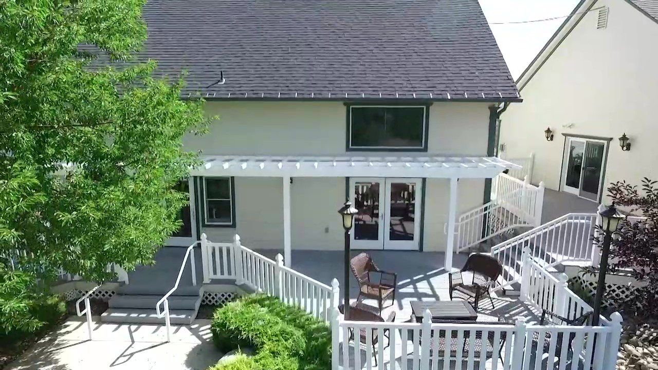 An aerial view of a house with a porch and patio