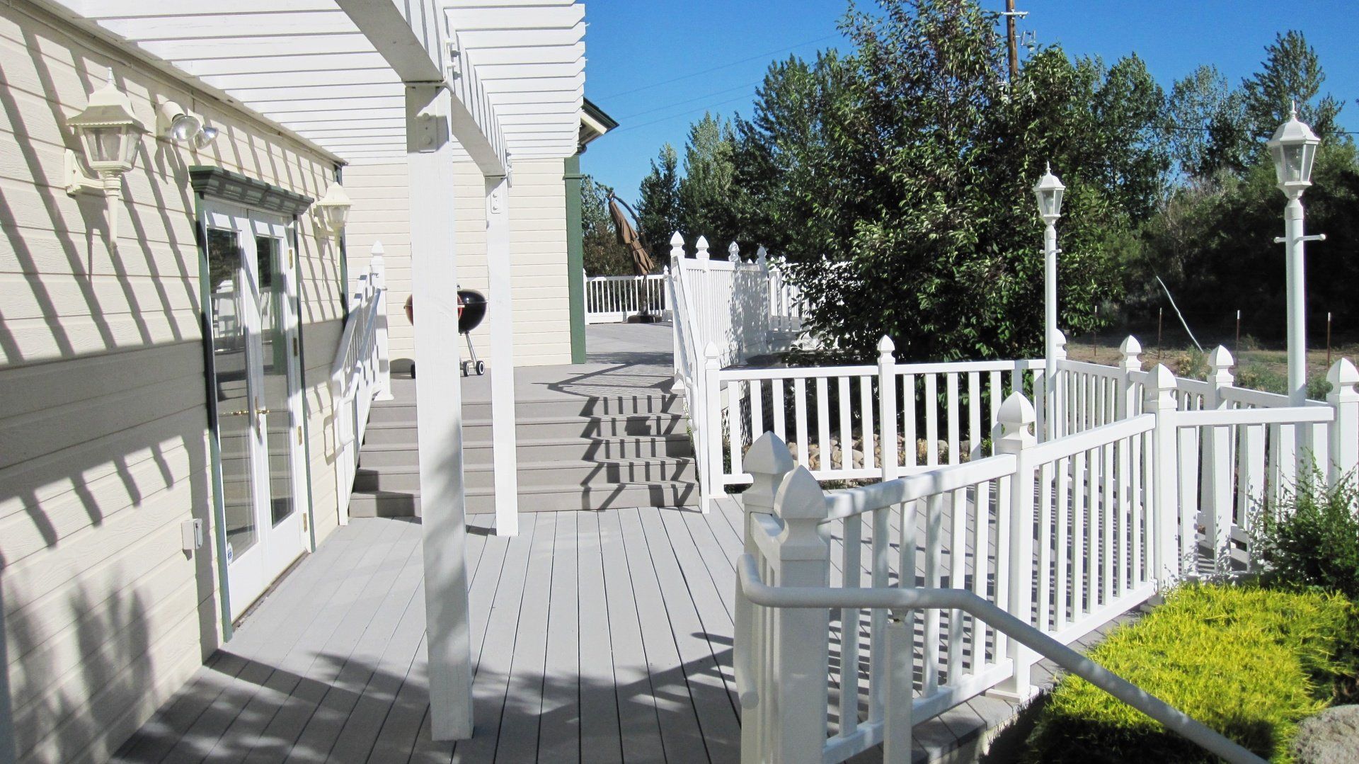 A white house with a white fence and stairs