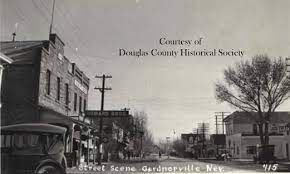 A black and white photo of a small town street scene taken by the congress of douglas county historical society.