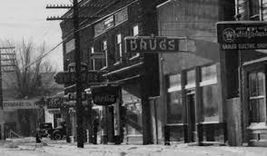 A black and white photo of a street with a sign that says `` drugs ''.