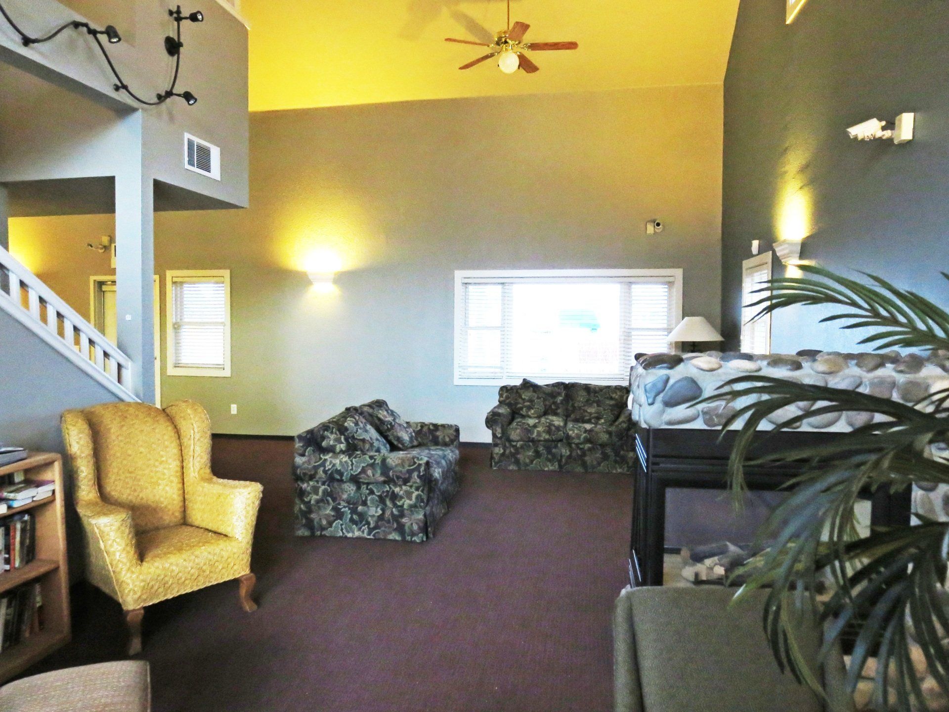 A living room filled with furniture and a ceiling fan