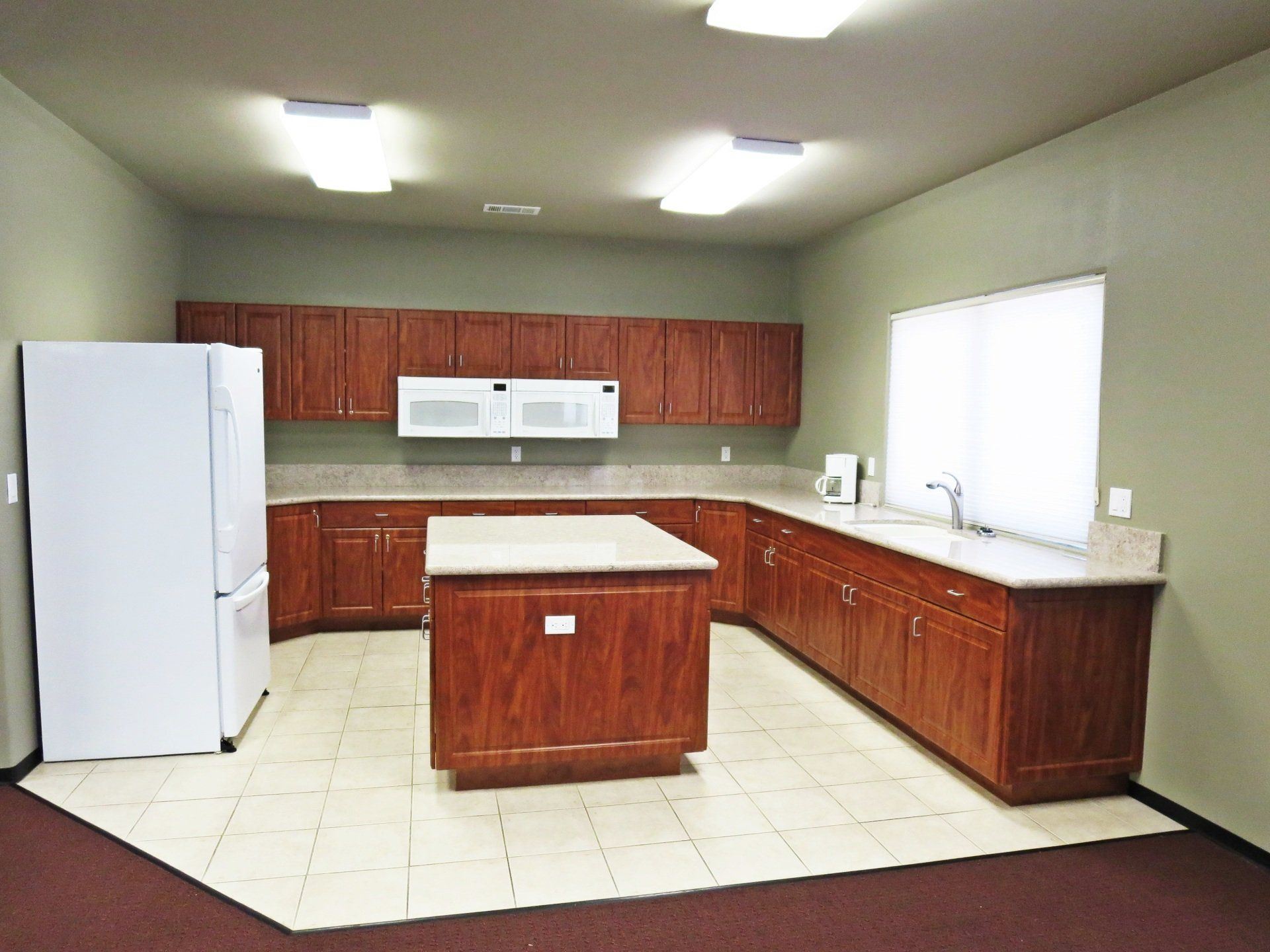 A kitchen with wooden cabinets and a white refrigerator