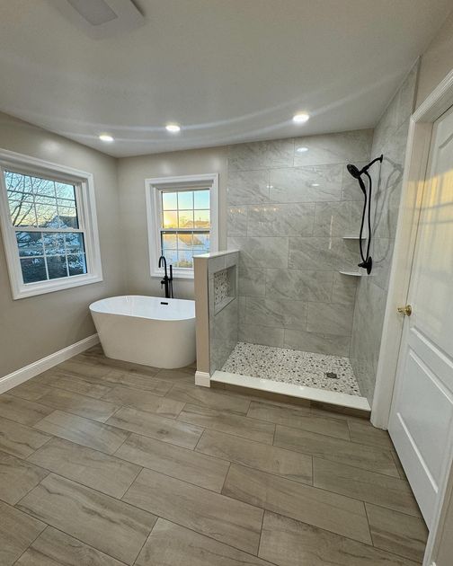 A bathroom with a tub and a walk in shower.