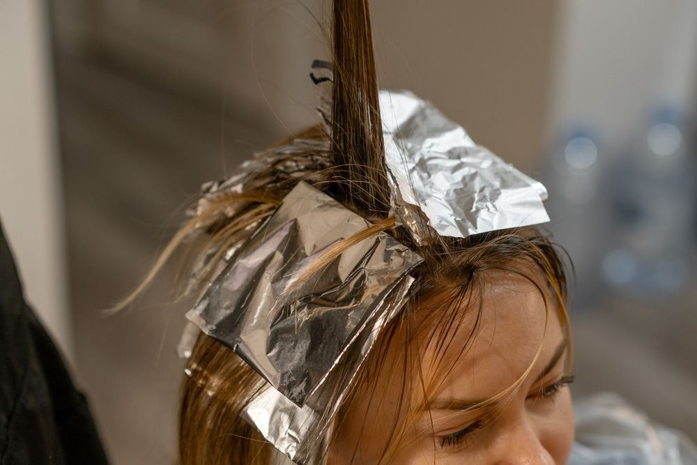 Hair highlighted with foil in a salon, near a person's face. — Amore 'D' Hair Studio in Mudjimba, QLD