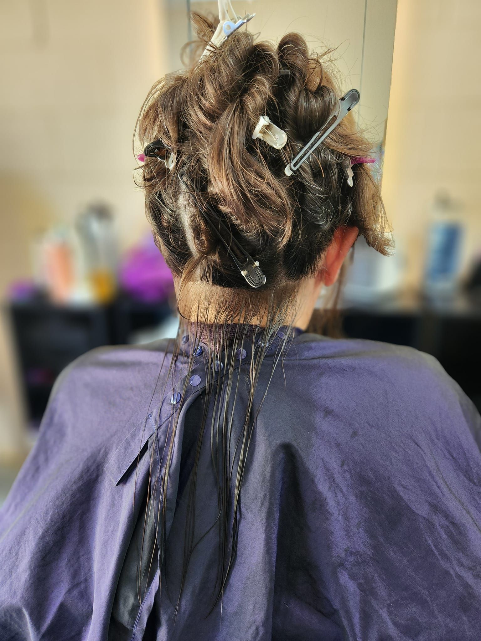 Person With Hair in Curlers, Wearing a Purple Cape in a Salon — Amore 'D' Hair Studio in Mudjimba, QLD