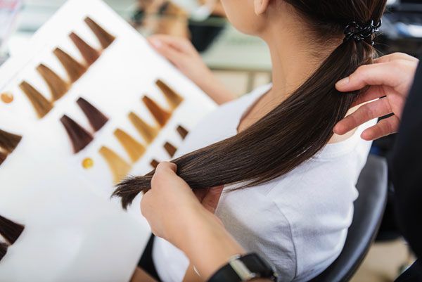 A Woman is Getting Her Hair Dyed by a Hairdresser — Amore 'D' Hair Studio In Mudjimba, QLD
