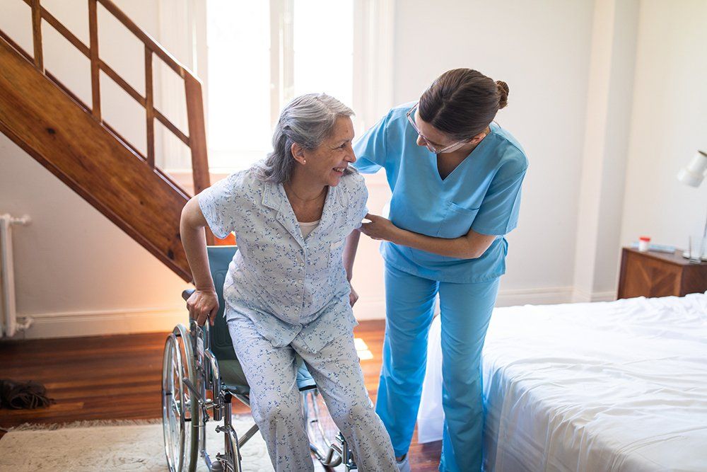 Female Nurse Helping Senior Woman | Saint Louis, MO | Alix Home Health Care.