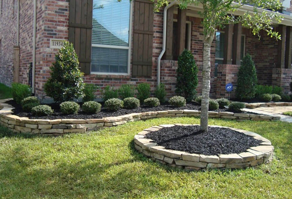 A brick house with a tree in the middle of the yard