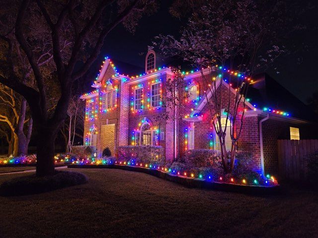 A house is decorated with christmas lights at night.