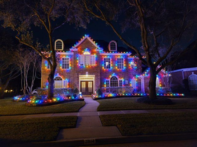 A house is decorated with christmas lights at night