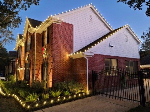 A house with christmas lights on the side of it