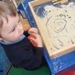 little boy doing art