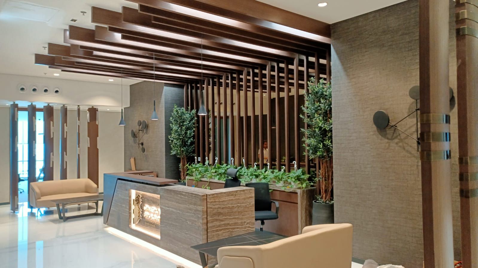 A private office in business bay Dubai, modern slick reception area with marble and wood finish by Concept Art Decor