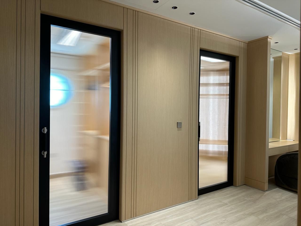 His walk-in closet with custom wardrobes in Jumeirah Park villa by Concept Art Decor.