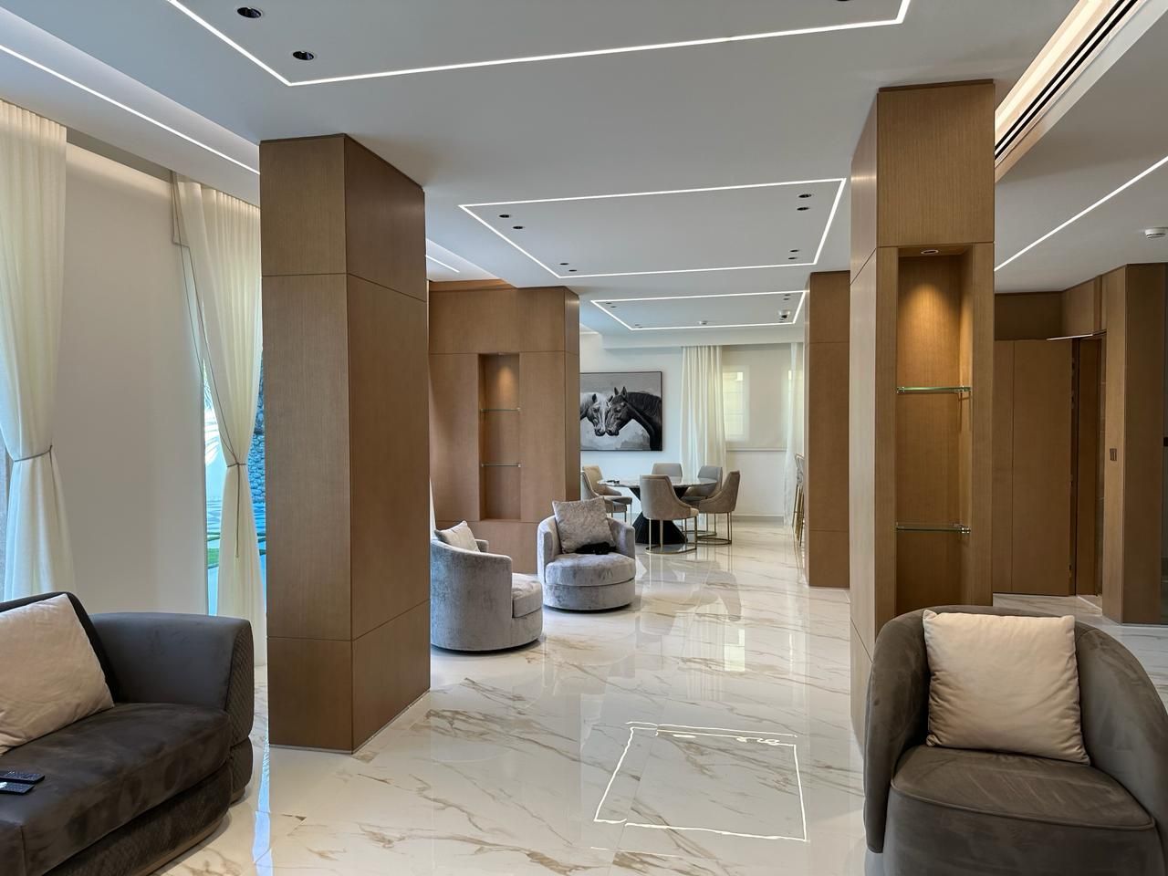 Family living area renovation in a Jumeirah Park villa with bespoke finishes by Concept Art Decor.