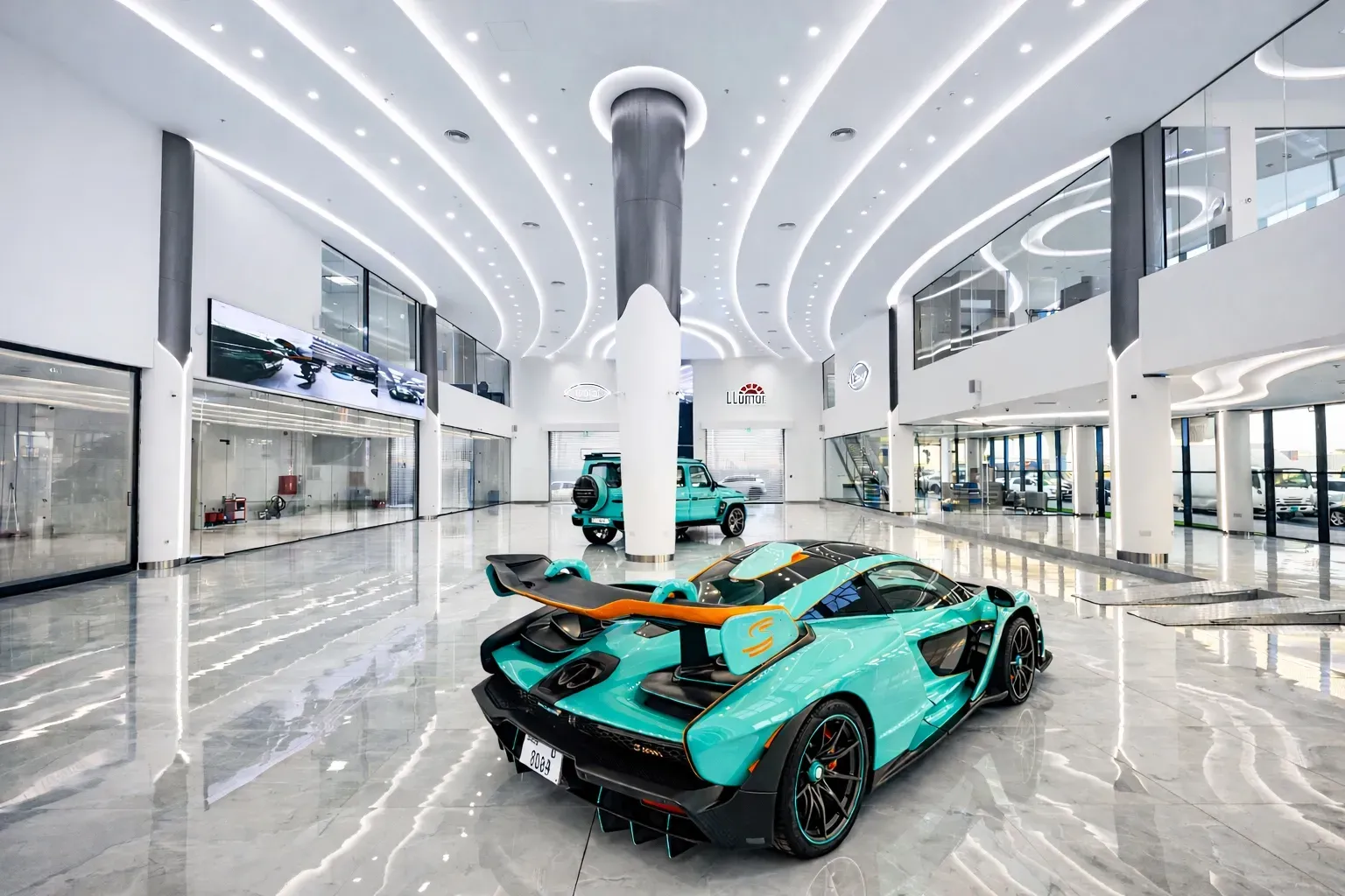 Luxury car showroom fit-out in Dubai featuring double-height architectural ceiling and premium vehicle display by Concept Art Decor