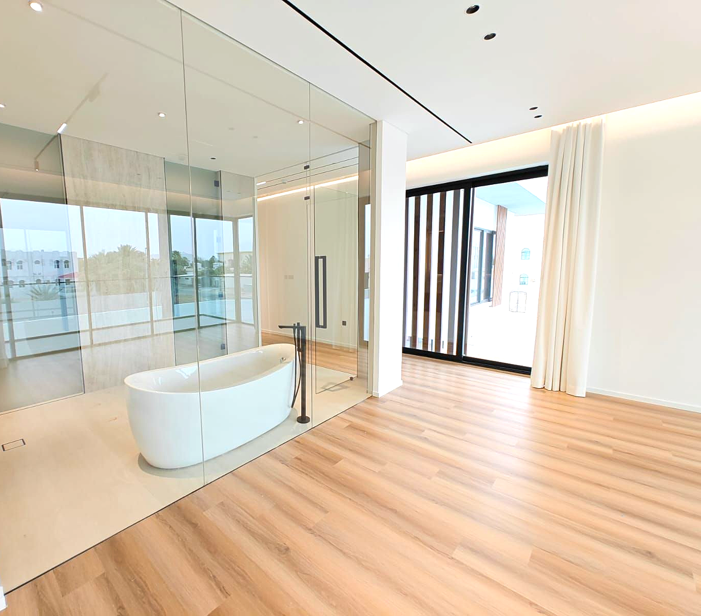 Luxury villa bathroom and interior finishing in Dubai featuring modern bathtub, glass partition and bespoke flooring completed by Concept Art Decor