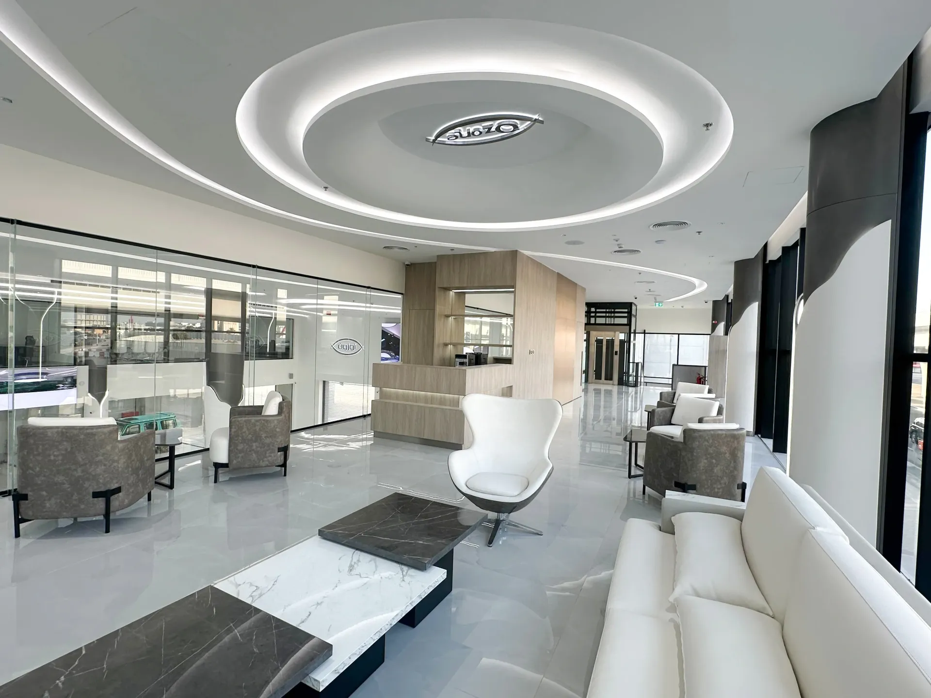 Bespoke showroom lounge interior in Dubai with premium joinery, seating, architectural ceiling by Concept Art Decor