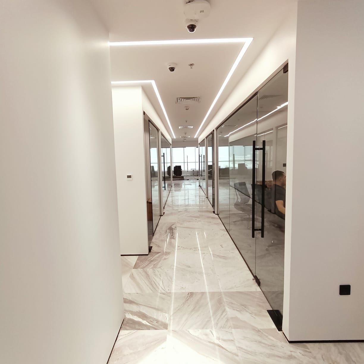 Dubai office fit-out with contemporary workspace layout and acoustic ceiling design.