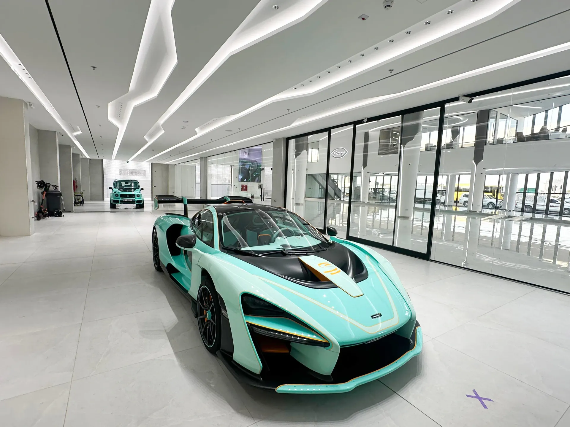 Geometric LED ceiling design above vehicle bay area in a luxury car showroom fit-out in Dubai by Concept Art Decor