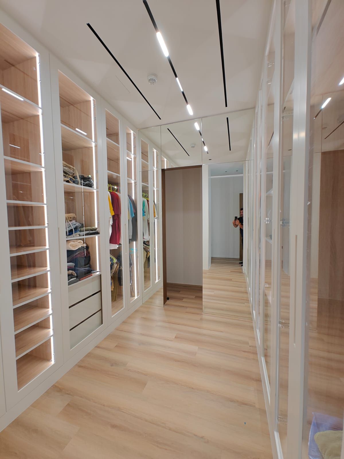 His walk-in closet with custom wardrobes in Dubai villa, built by Concept Art Decor.
