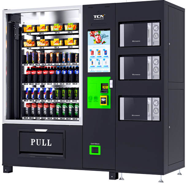 Vending machine with snacks, drinks, and microwaves. Black with a touch screen and card reader.